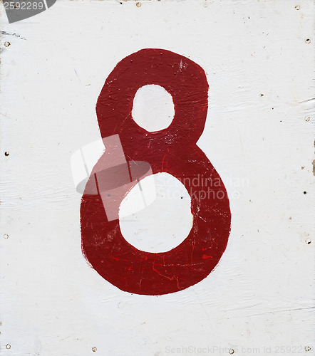 Image of number eight on white plywood board