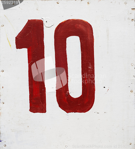 Image of number ten on white plywood board