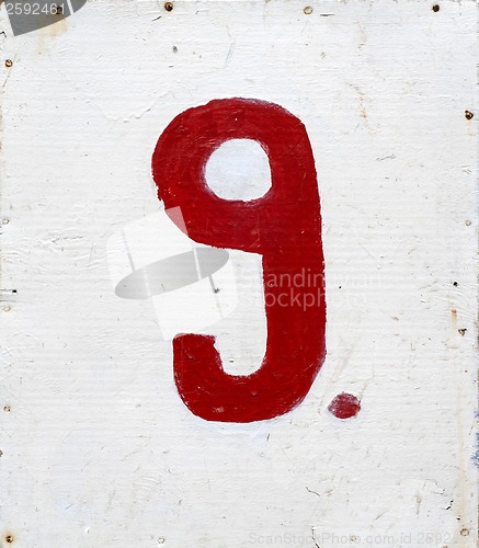 Image of number nine on white plywood board