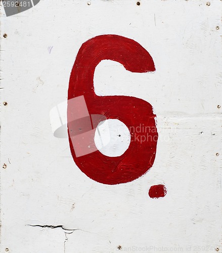 Image of number six on white plywood background