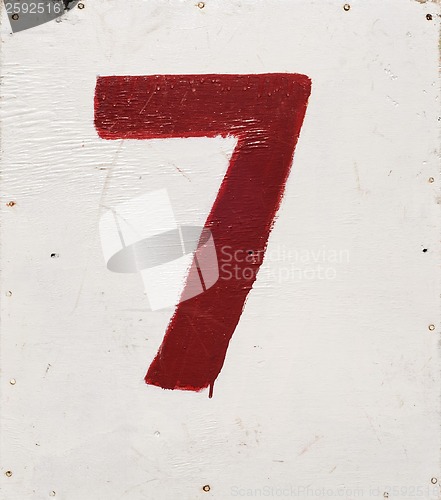 Image of number seven on white plywood board