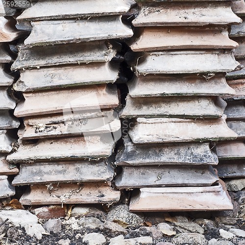 Image of Pile of brown hearth tiles on the ground