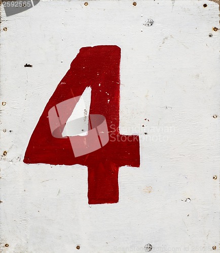 Image of number four on white plywood board