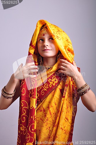 Image of little girl in traditional Indian clothing and jeweleries