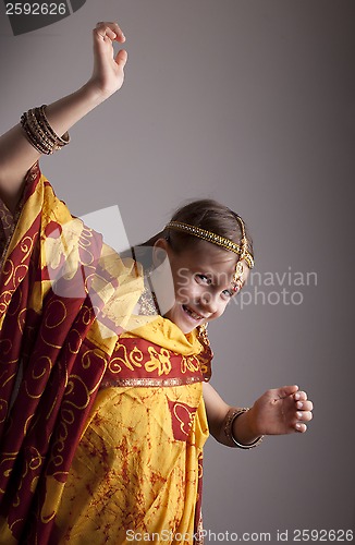 Image of dancing little girl in traditional Indian clothing and jewelerie