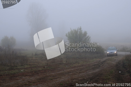 Image of Car on the Dirt Road on the Foggy Day