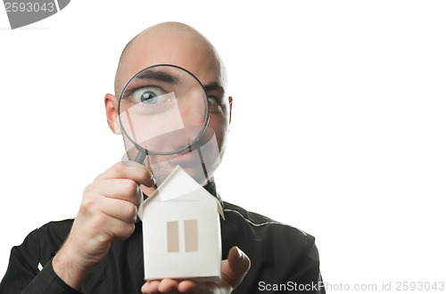 Image of Man with a magnifying glass and paper house