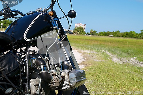 Image of antique motorcycle on dirt road