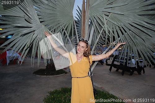 Image of woman on a background of palms