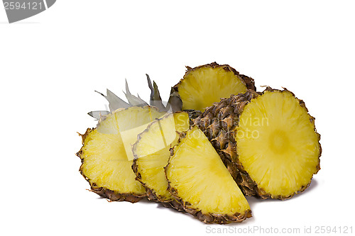 Image of Pineapple and slices of pineapple on a white background.