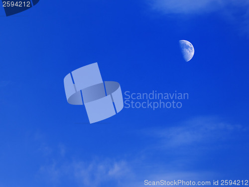 Image of Evening blue sky with moon in corner