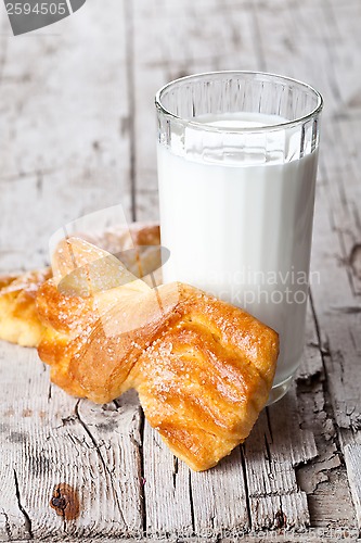 Image of glass of milk and two fresh baked buns 