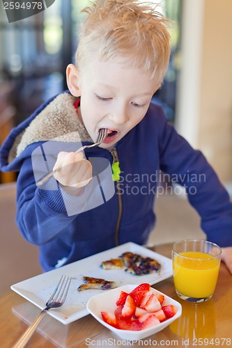Image of child eating breakfast