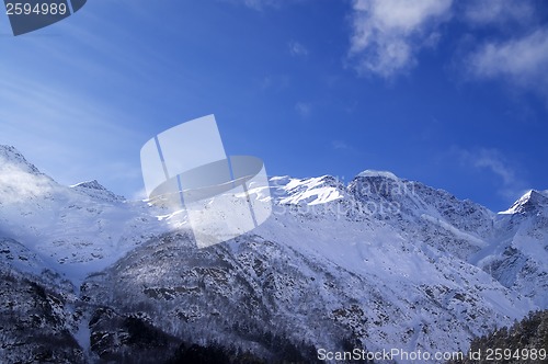 Image of Snowy sunlight mountains, view from ski slope