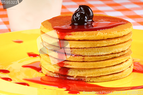 Image of Pancakes with syrup and sour cherries