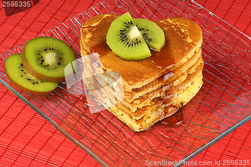 Image of Heart-shaped pancakes with syrup and kiwi fruit