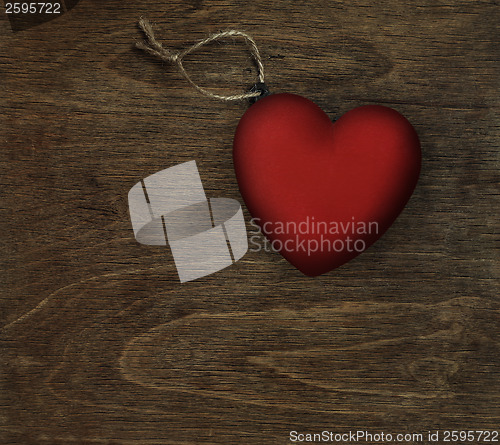 Image of red heart on dark wood