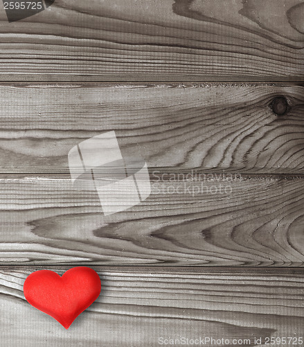 Image of red heart on dark wooden planks