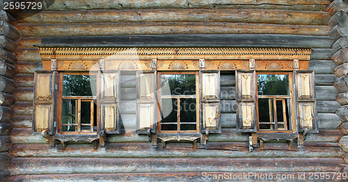 Image of old russian wooden house with decorated windows