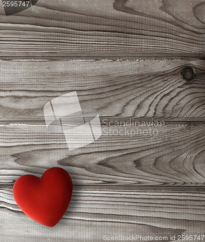 Image of red heart on dark wooden planks