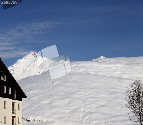 Image of Off-piste slope and hotel in winter mountains