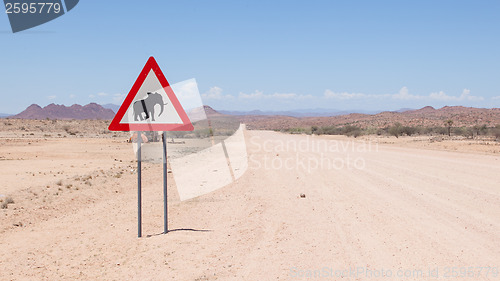 Image of Caution: Elephants! Road sign standing beside road