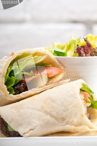 Image of kafta shawarma chicken pita wrap roll sandwich