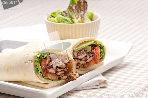 Image of kafta shawarma chicken pita wrap roll sandwich