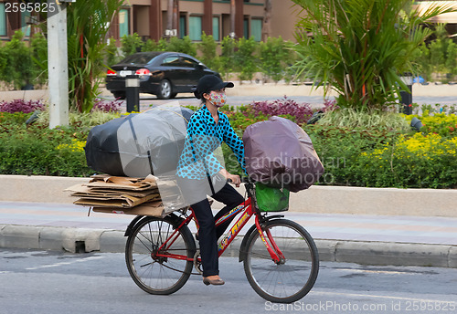 Image of Patong  - APRIL 26: Thai woman takes out the garbage in bags on 
