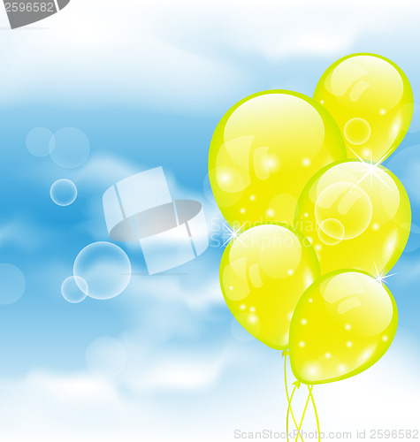 Image of Flying yellow balloons in blue sky