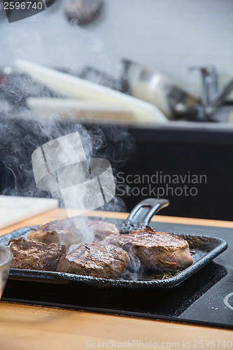 Image of Meat slices roasted on skillet 