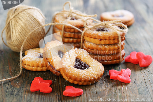 Image of Red marzipan hearts, cookies and ball of twine.