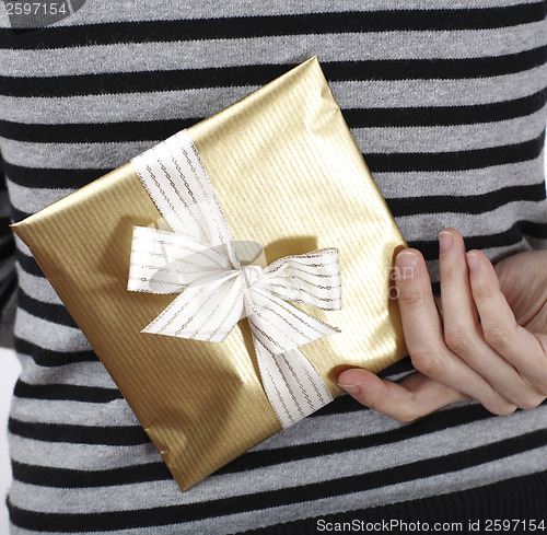 Image of Young woman holding a present