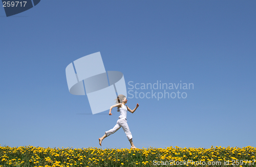 Image of Happy girl running in dandelion field