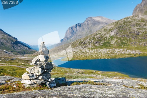 Image of Stack of rocks with mountain and lake view