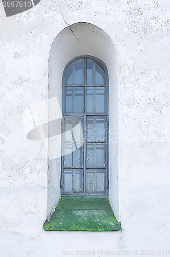 Image of Old window on a white wall.