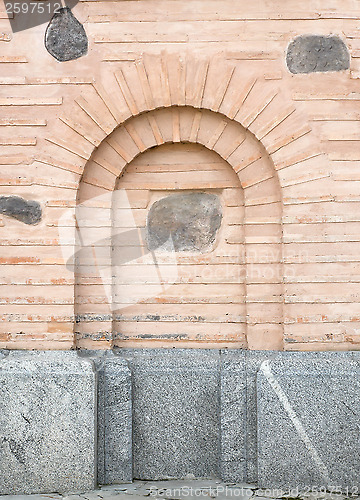 Image of Old brick wall with arch imitation.