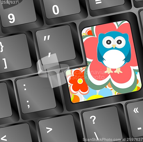 Image of owl on computer keyboard key with flowers