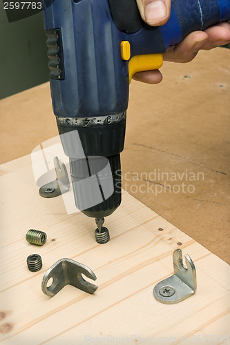 Image of Fastening with an screwdriver furniture parts