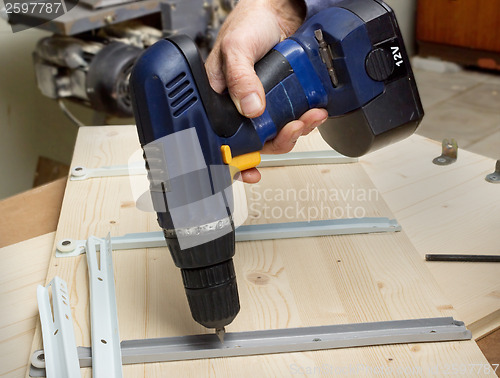 Image of Fastening with an electric screwdriver furniture wooden parts