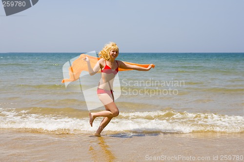 Image of Girl runs on beach