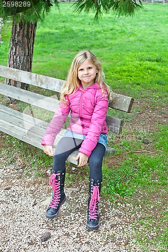 Image of girl sitting on a bench in the park