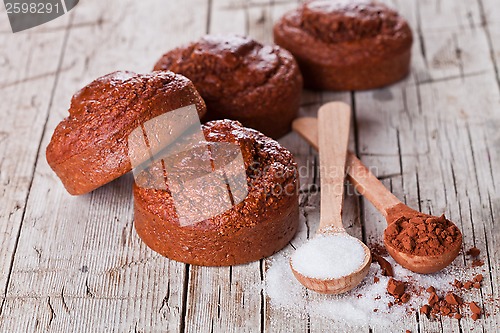 Image of fresh baked browny cakes, sugar and cocoa powder