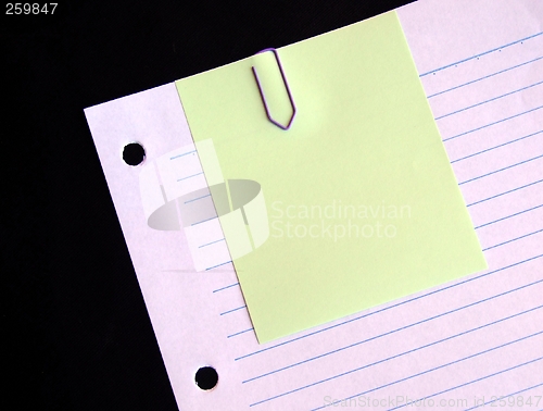 Image of Clipped yellow paper on lined paper background