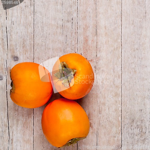 Image of three fresh persimmons 