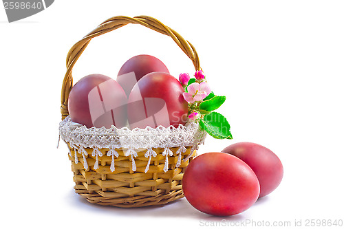 Image of Red Easter eggs in a basket on a white background.