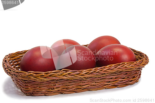 Image of Red Easter eggs in a basket on a white background.