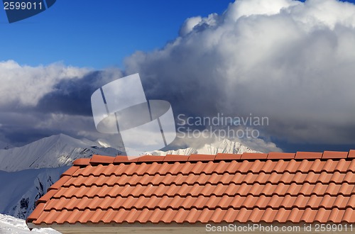 Image of Roof tiles and snowy mountains