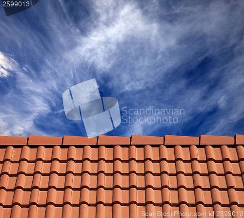 Image of Roof tiles and sky with clouds at sun day