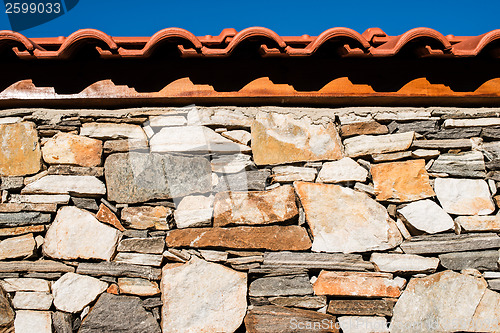 Image of Wall built of stones. Sun light